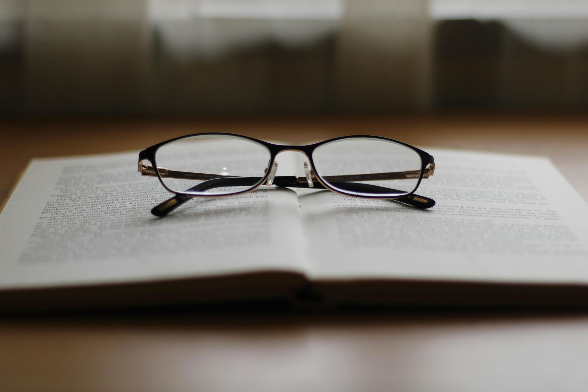 Pair of Reading Glasses Set on Open Book