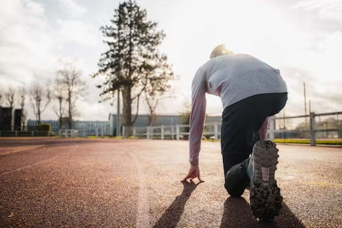 A man is getting ready to run on a track.