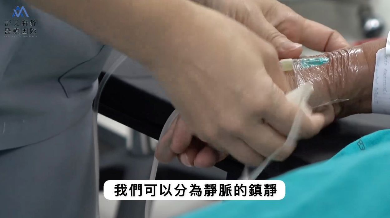 A person is holding another person 's hand in a hospital bed.