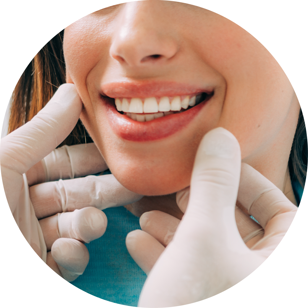 A woman is getting her teeth examined by a dentist