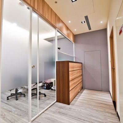 A hallway with sliding glass doors and a wooden dresser