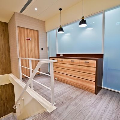 A room with stairs and a dresser with drawers