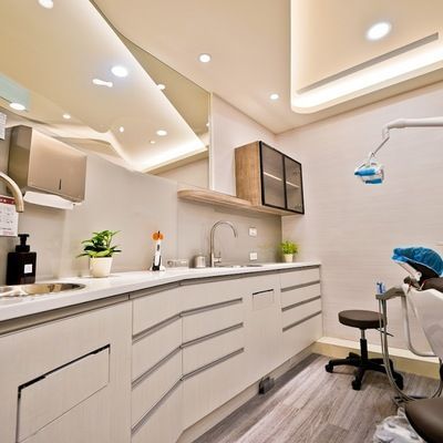 A dental office with a sink and a dental chair