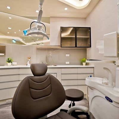 A dental office with a dental chair and a sink