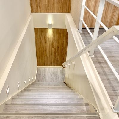 A staircase with wooden steps and a white railing