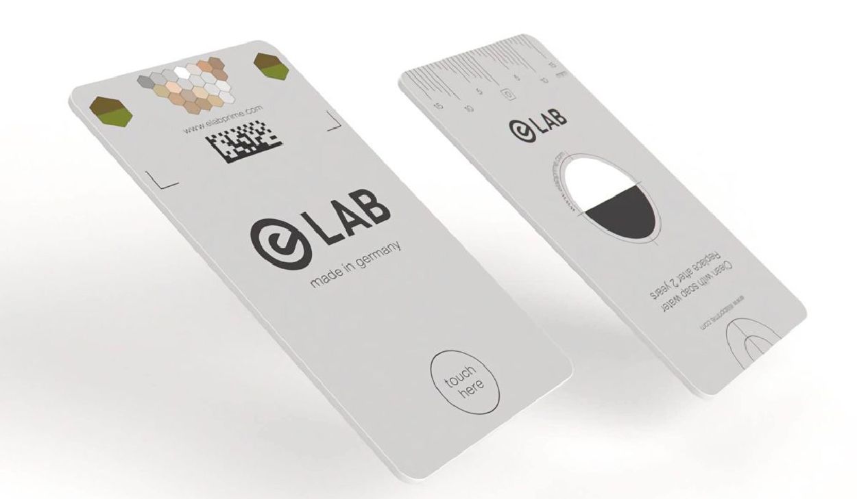 Two white cards with the word lab on them are laying on a white surface.