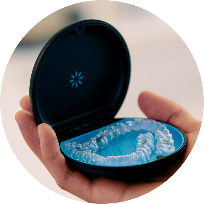 A person is holding an invisalign case in their hand