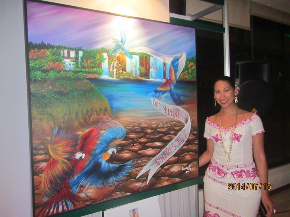 A woman stands in front of a large painting of birds