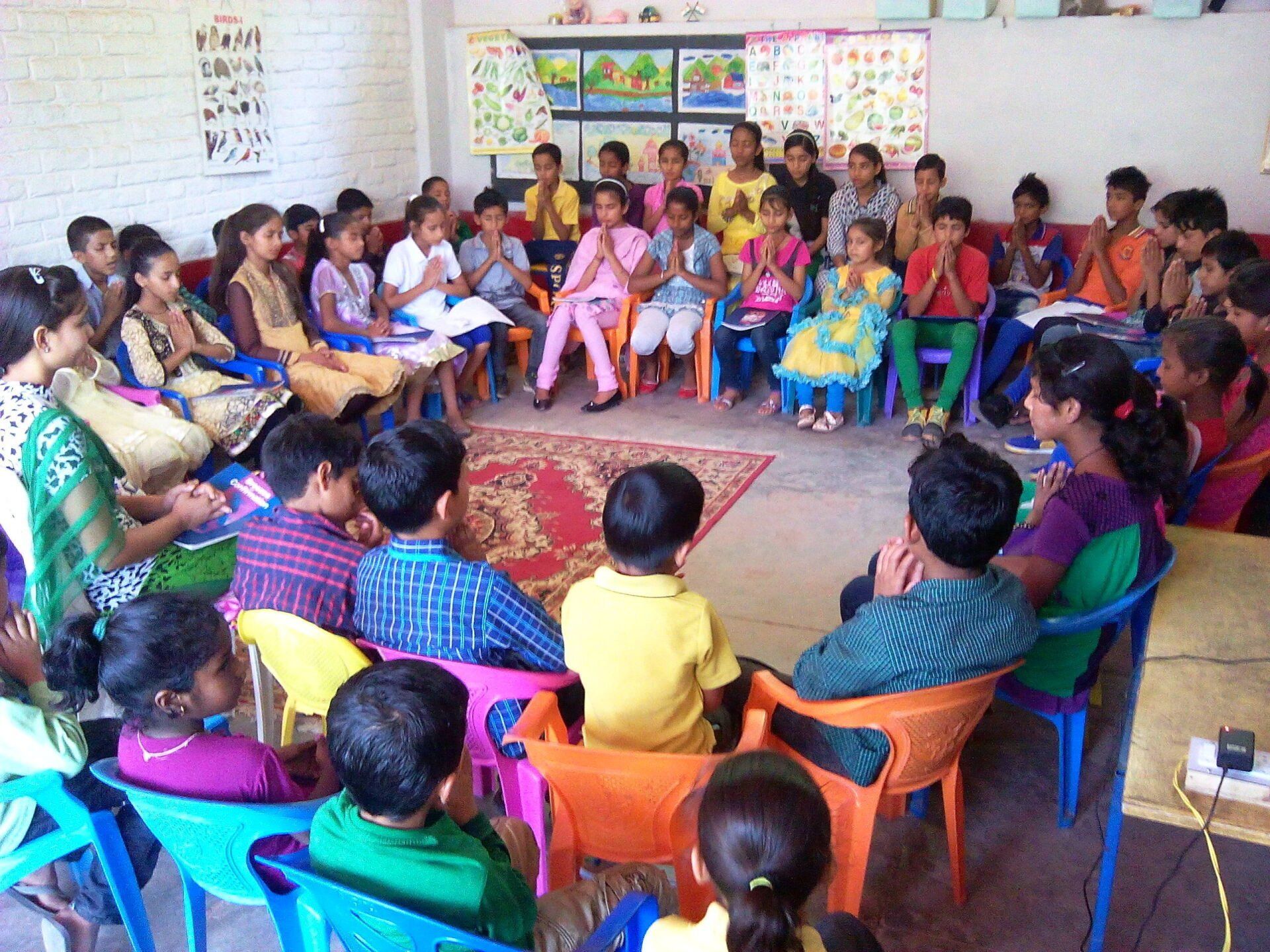 A group of children are sitting in a circle in a classroom