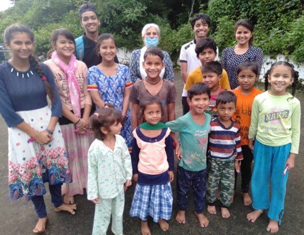 A group of children are posing for a picture with their parents