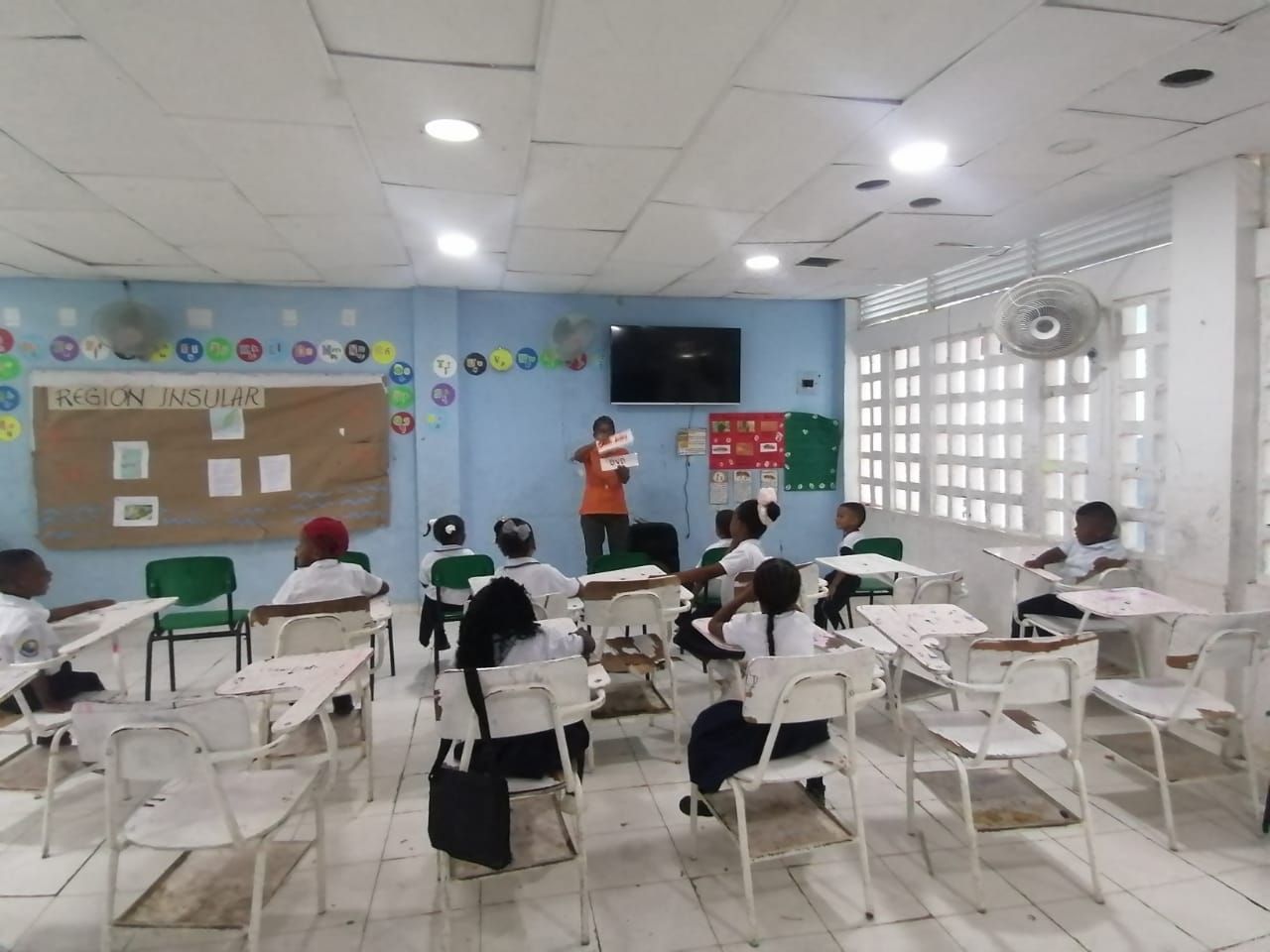 A group of children are sitting at desks in a classroom