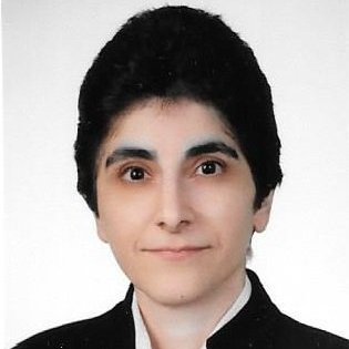 A woman with short black hair is wearing a black jacket and white shirt.