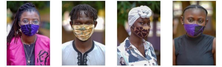 A group of people wearing face masks are standing next to each other.
