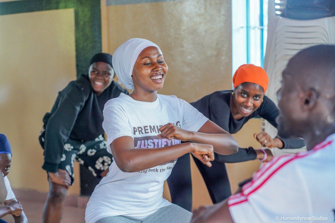 A group of people are dancing together in a room.