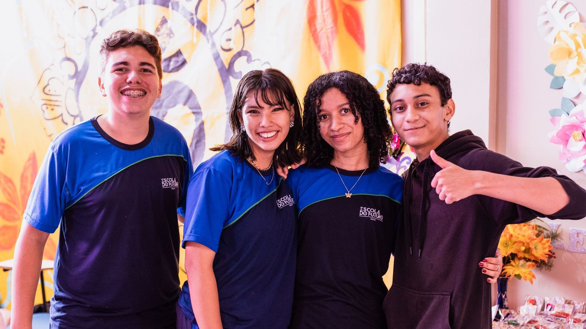 A group of young people are posing for a picture together.