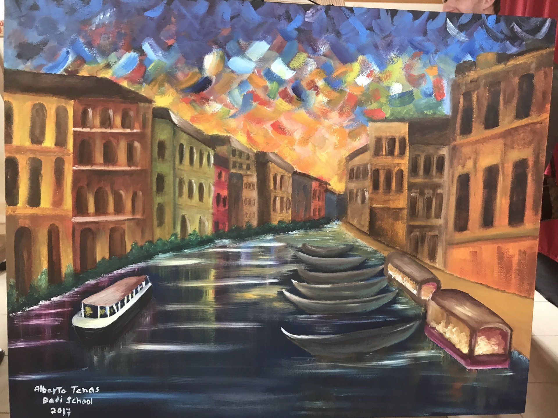 A painting of a canal with boats and buildings