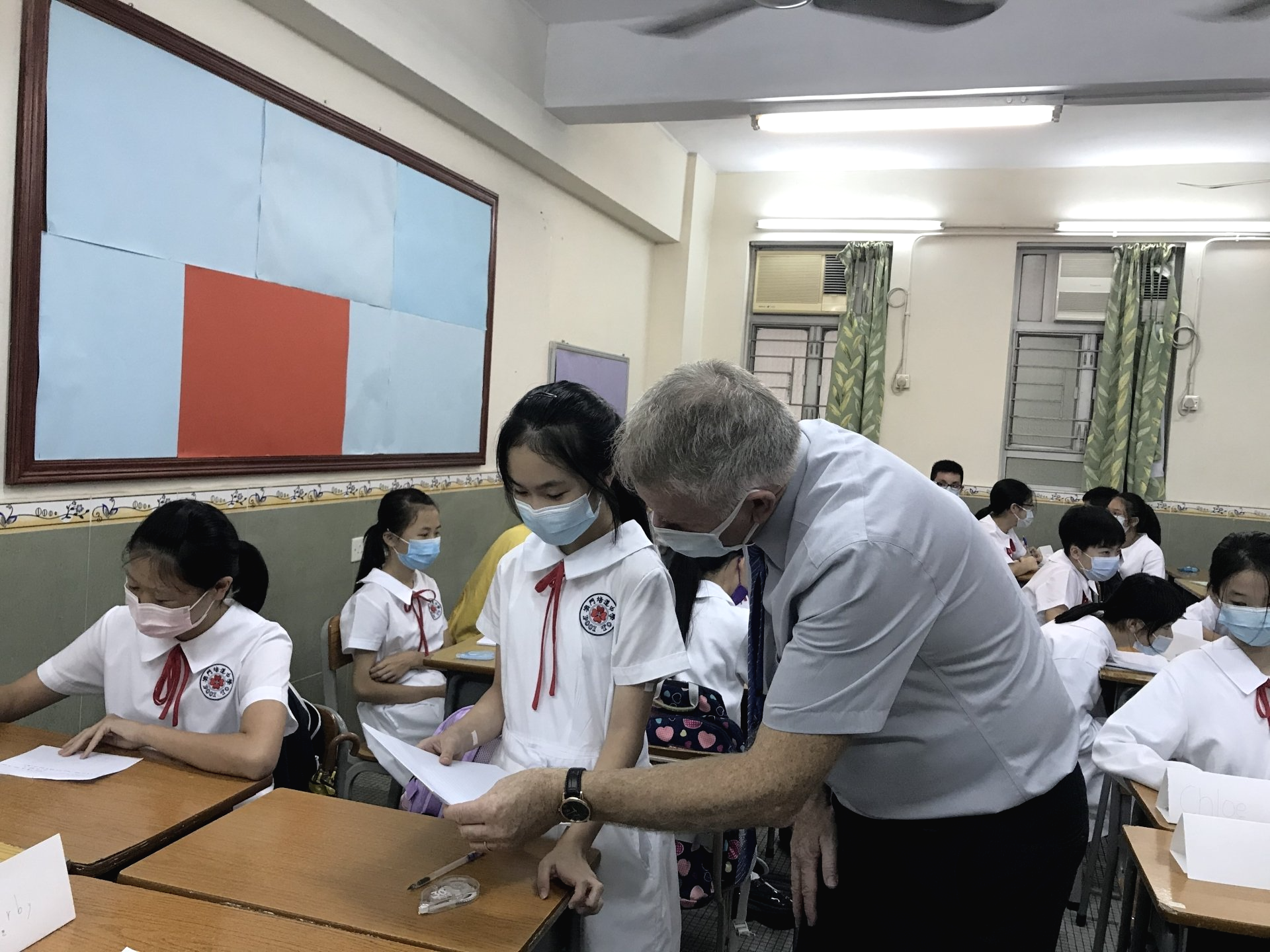 A young student and teacher working together on homework. 