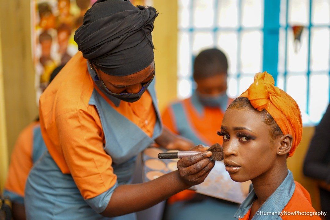 A woman is applying makeup to another woman 's face.