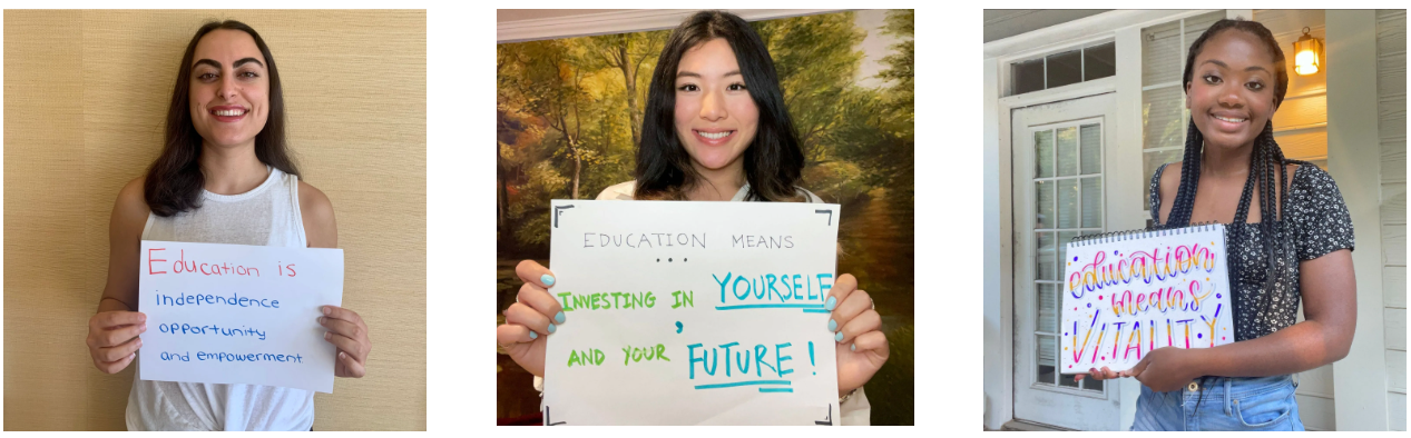 Three young women are holding signs in their hands.