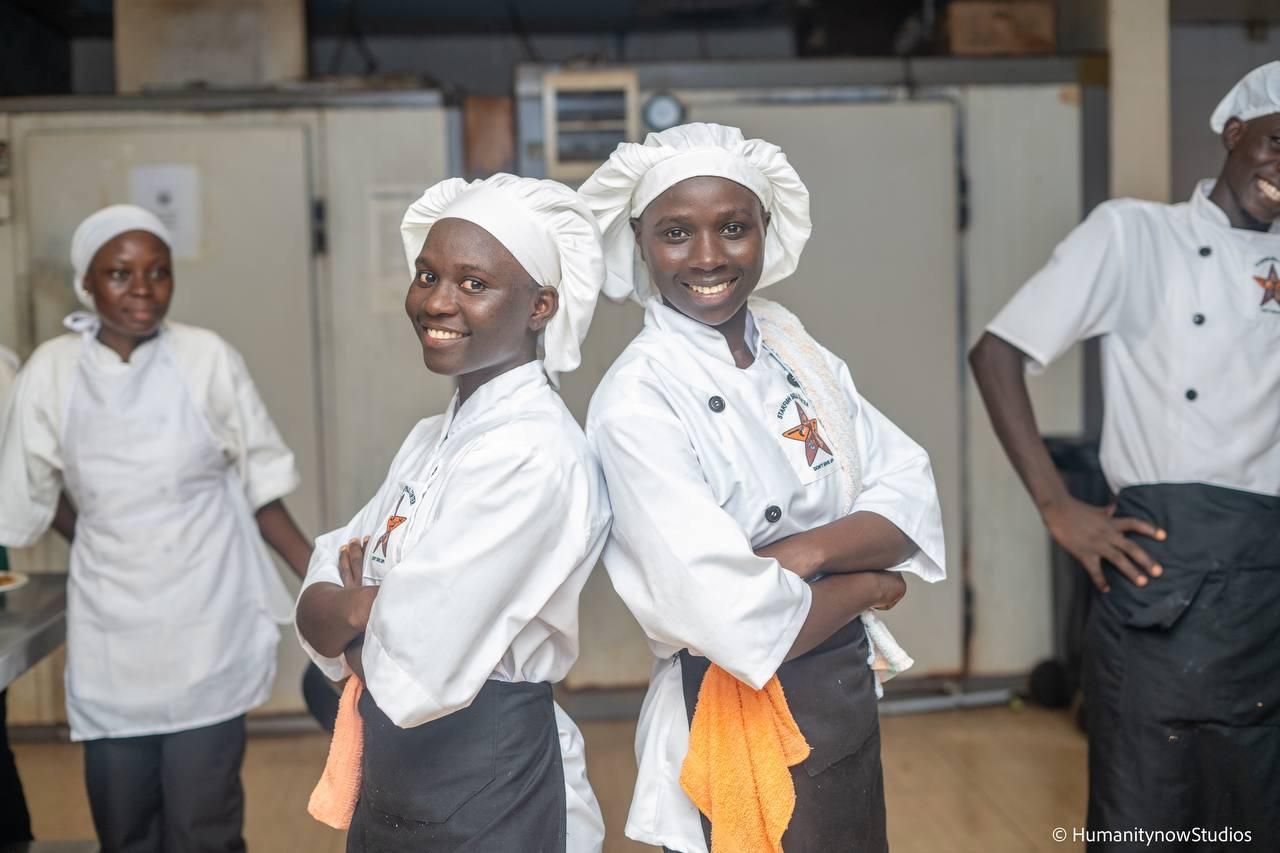A group of chefs are posing for a picture with their arms crossed