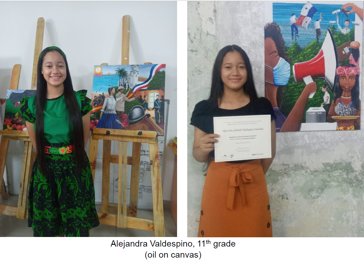 A girl is standing in front of a painting and holding a certificate.