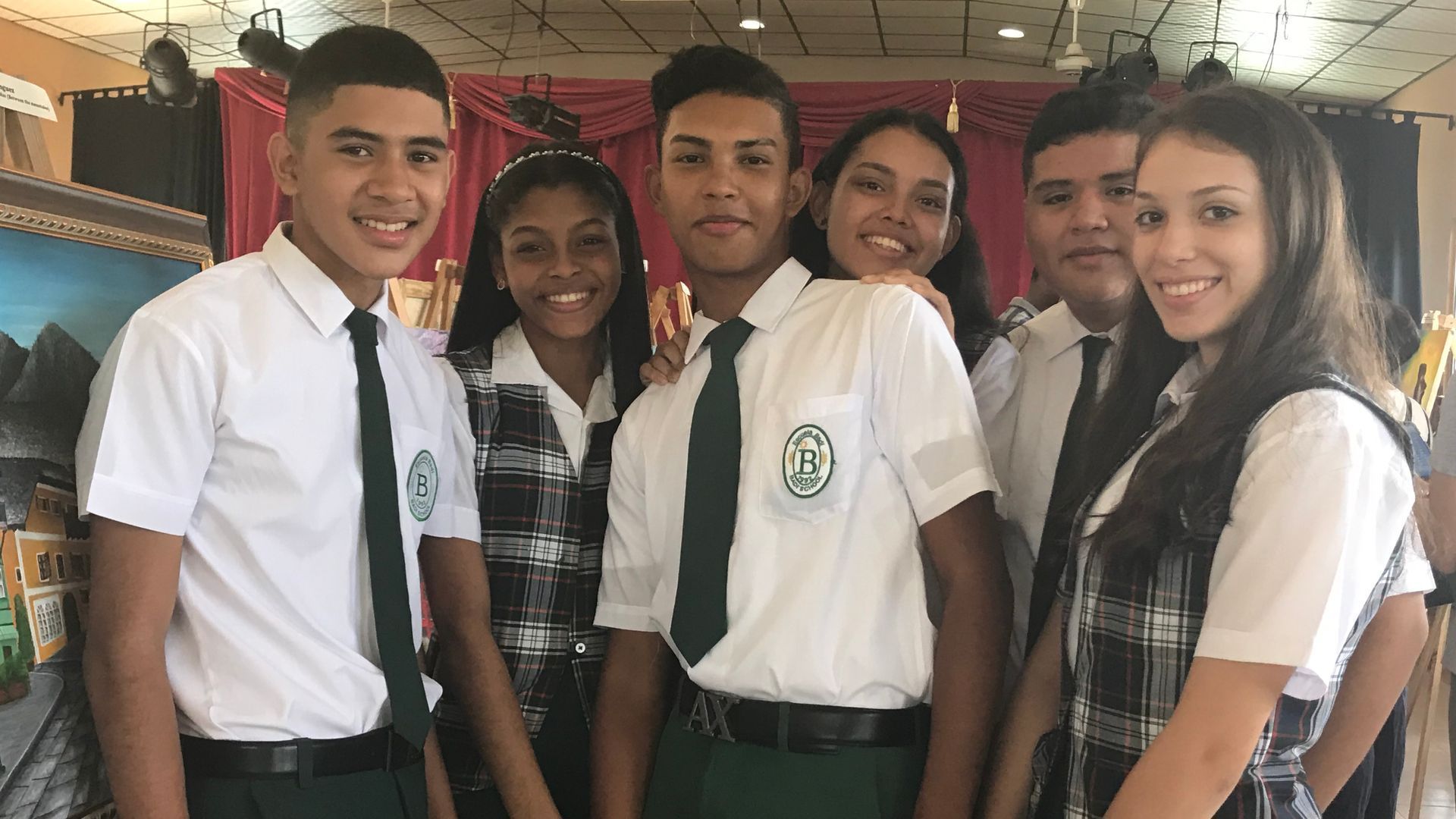 A group of young people in school uniforms are posing for a picture.