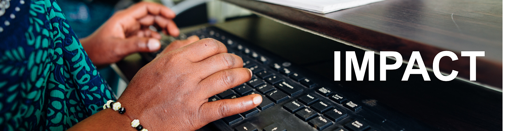 A woman is typing on a computer keyboard with the word impact above her