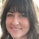 A close up of a woman 's face with a smile on her face.
