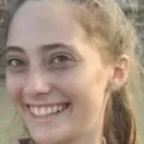 A close up of a woman 's face smiling.