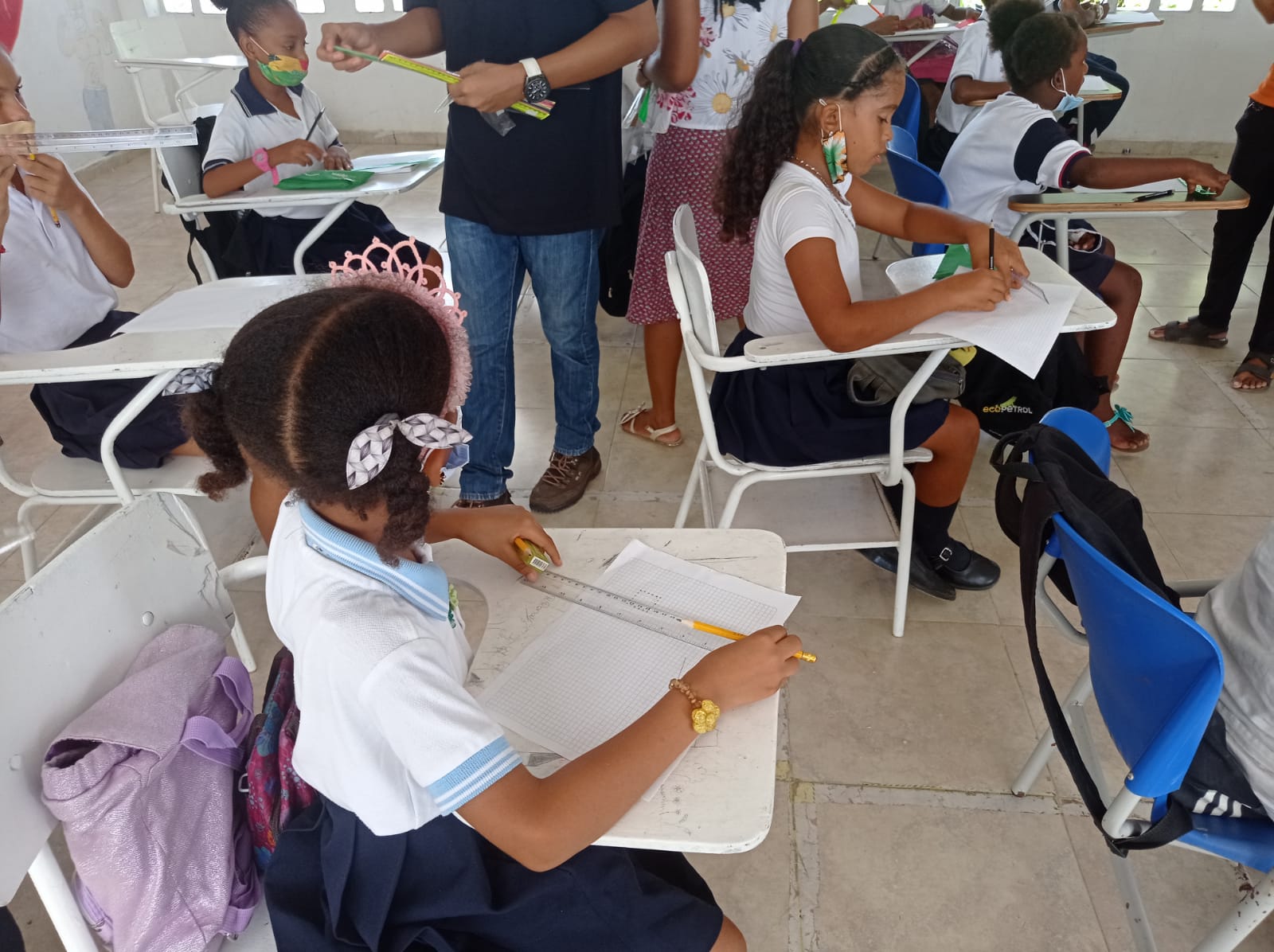 A group of children are sitting at desks in a classroom.