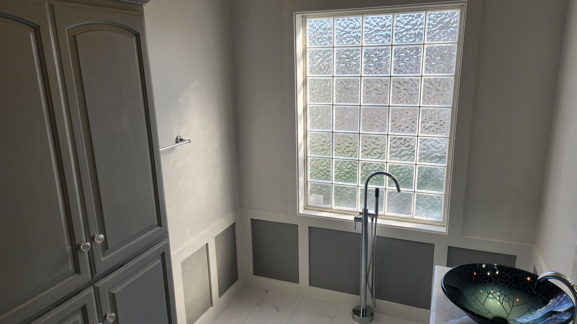 A bathroom with a sink and a window.