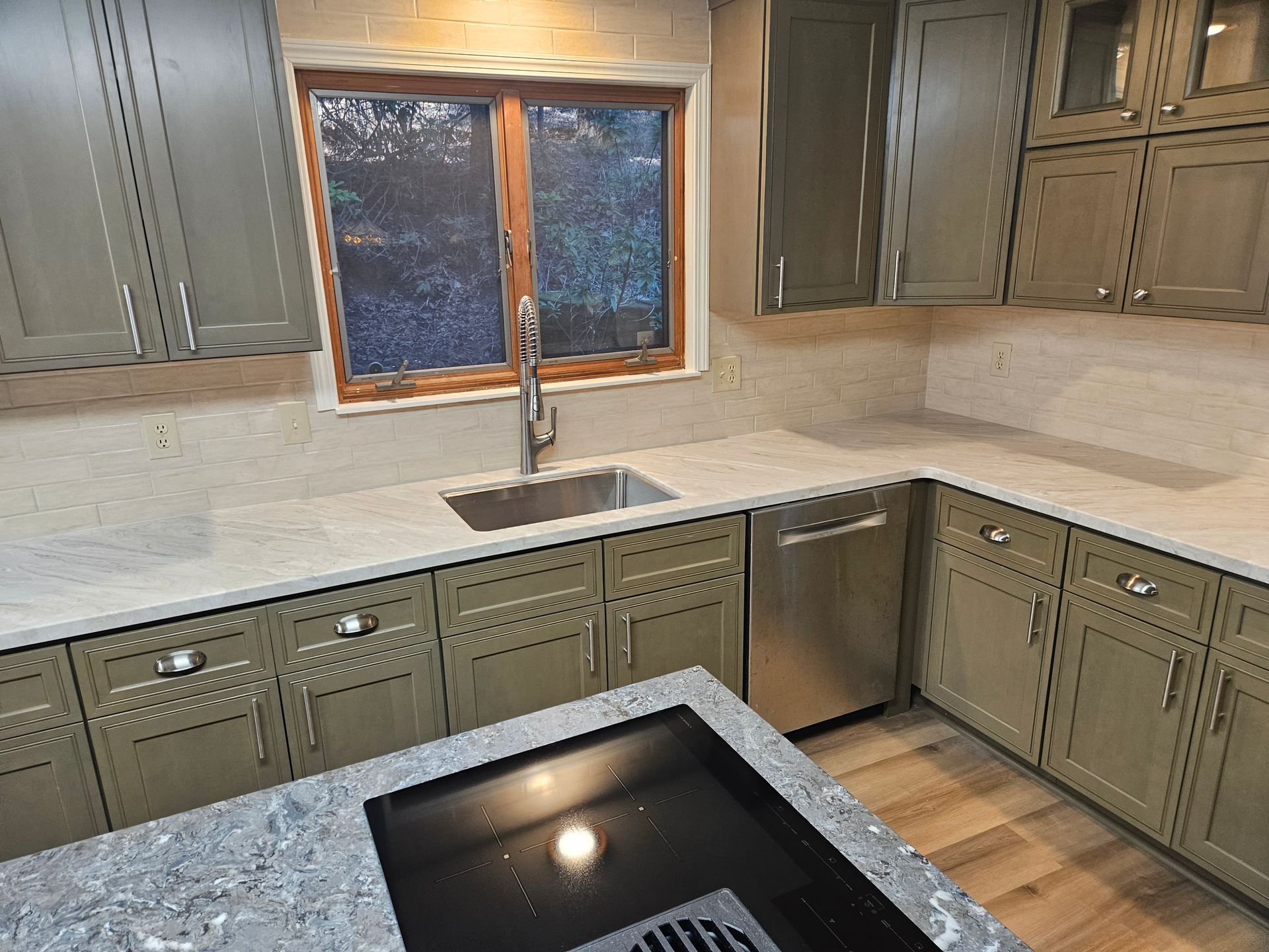 A kitchen with stainless steel appliances and a sink