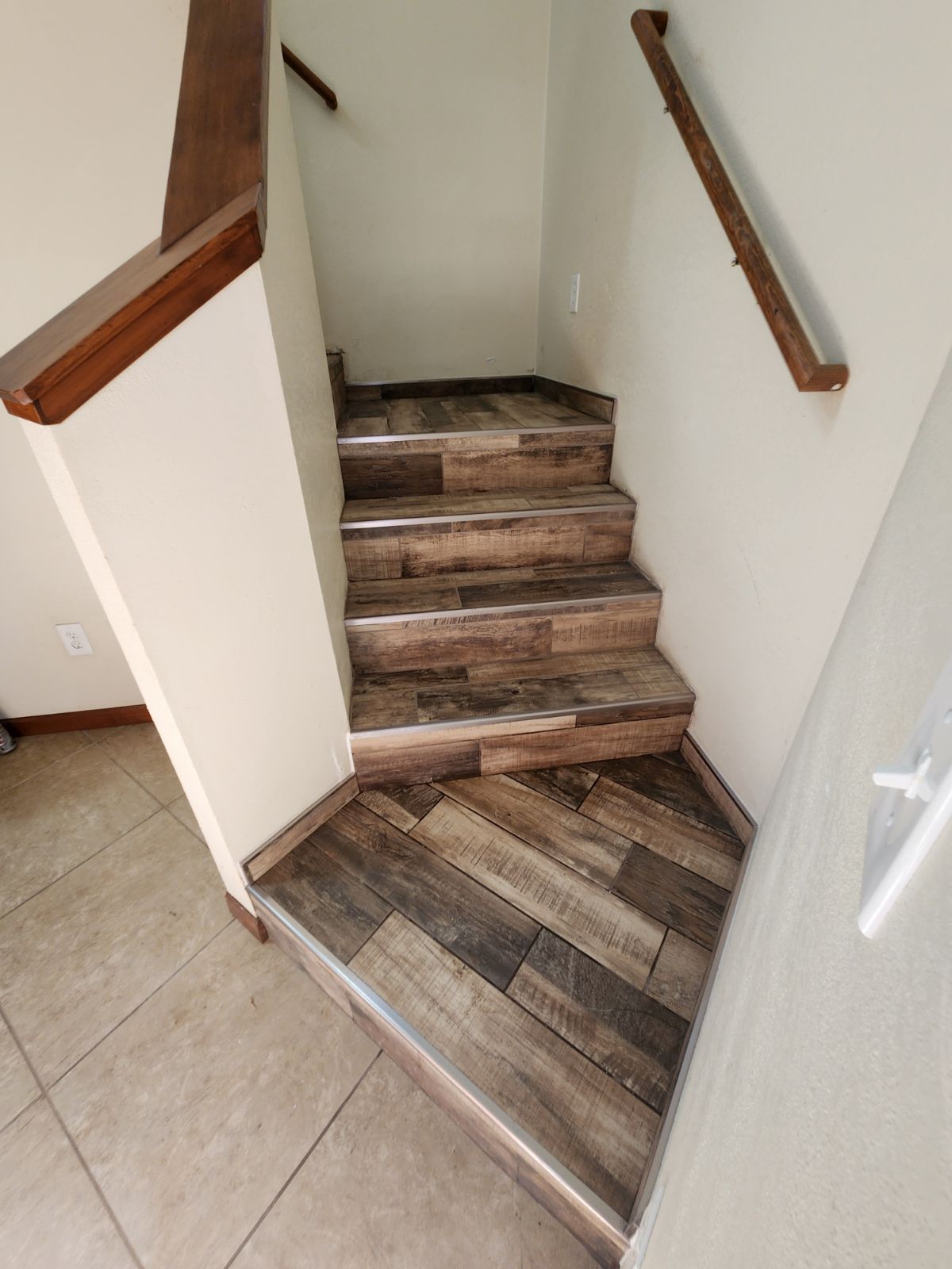 A set of wooden stairs leading up to the second floor of a house.