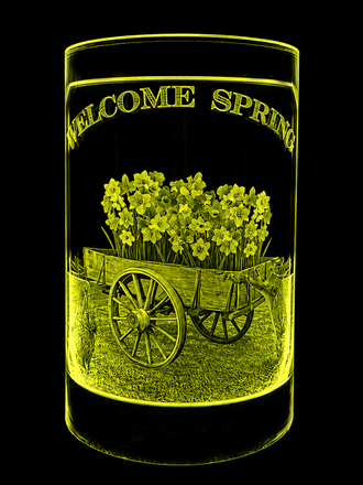 Yellow floral design on a black cylinder with arched text and a cart illustration