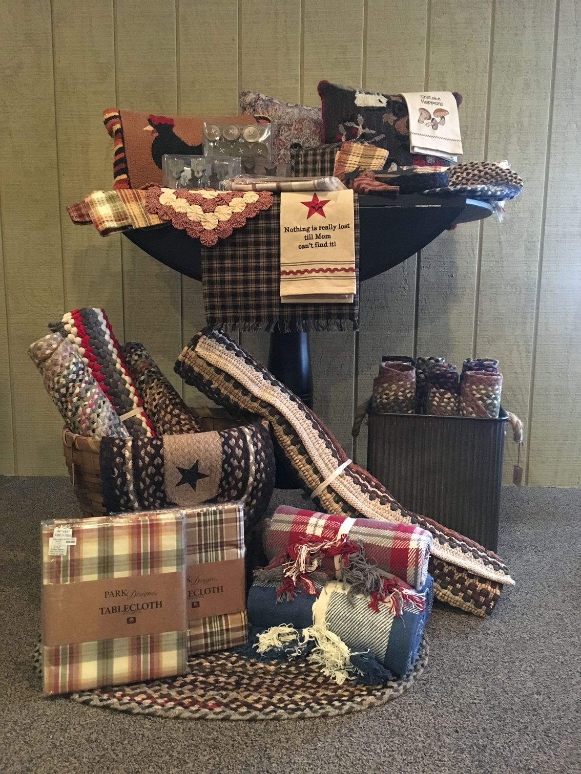 A table with a bunch of blankets and pillows on it