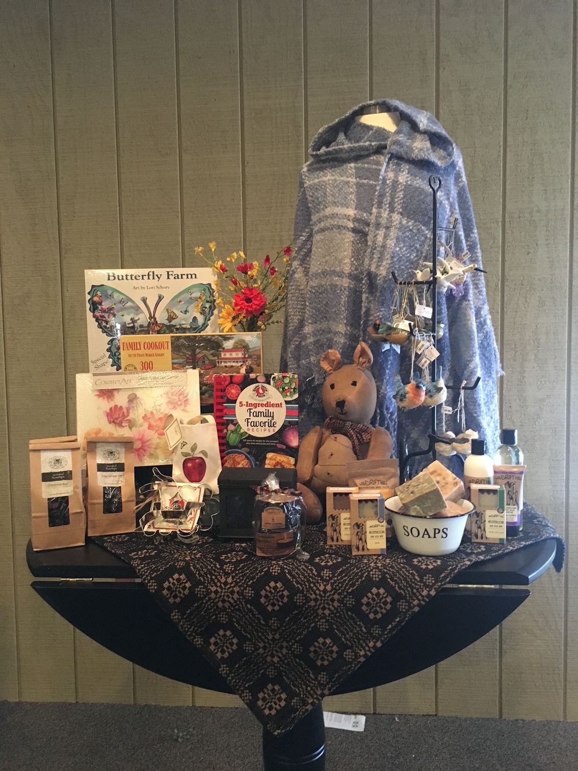 A table with a teddy bear and other items on it
