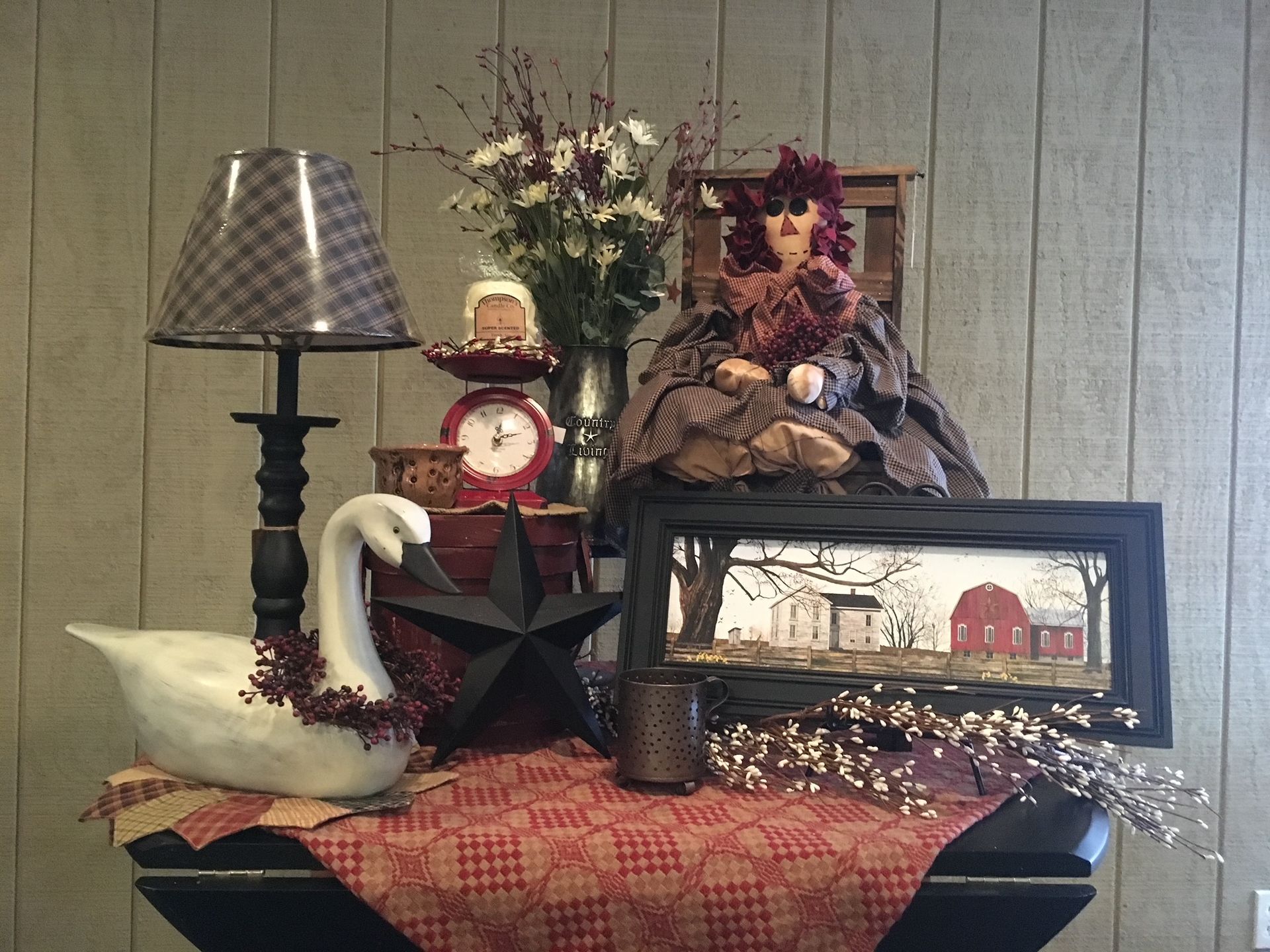A table with a swan lamp and a clock on it