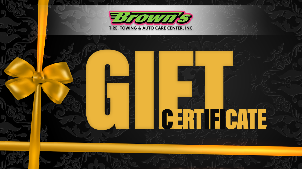 Brown's Towing & Auto Care gift certificate with gold bow, on black patterned background.