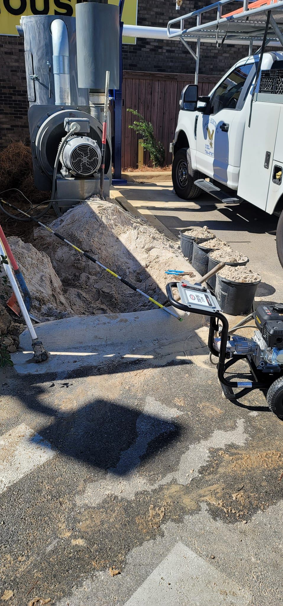 Construction site with a truck, equipment, and concrete work.