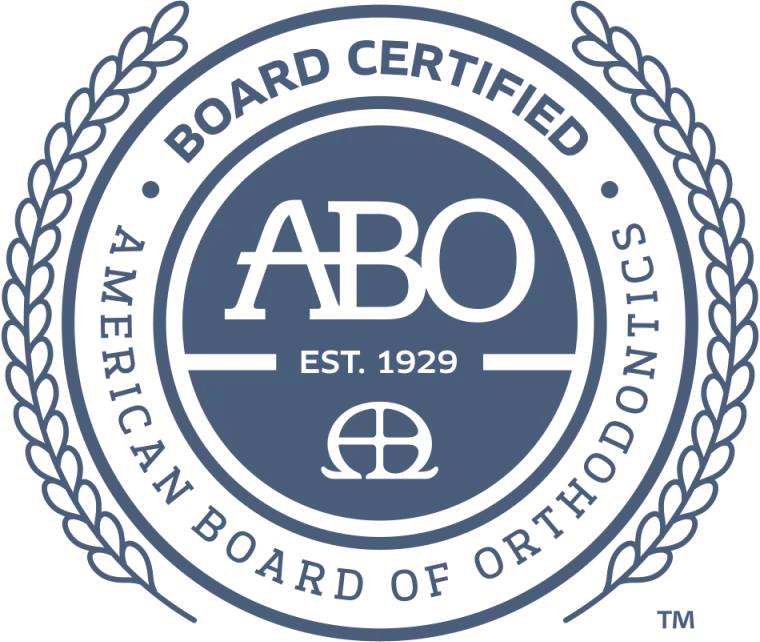 American Board of Orthodontics seal, blue and white, with text and a wreath.