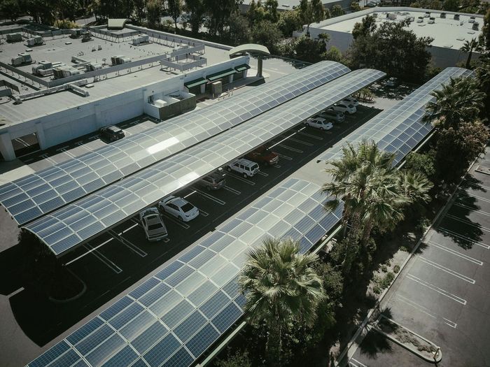 Project Complation and Follow-Up Aerial shot of large-scale solar carports installed to reduce energy costs.
