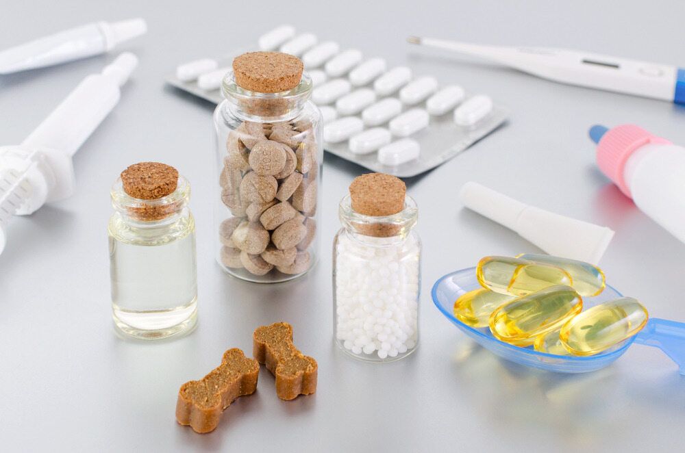 A Table Topped With Bottles of Pills , a Thermometer , and a Spoon of Fish Oil — Farm and Home in Nabiac, NSW