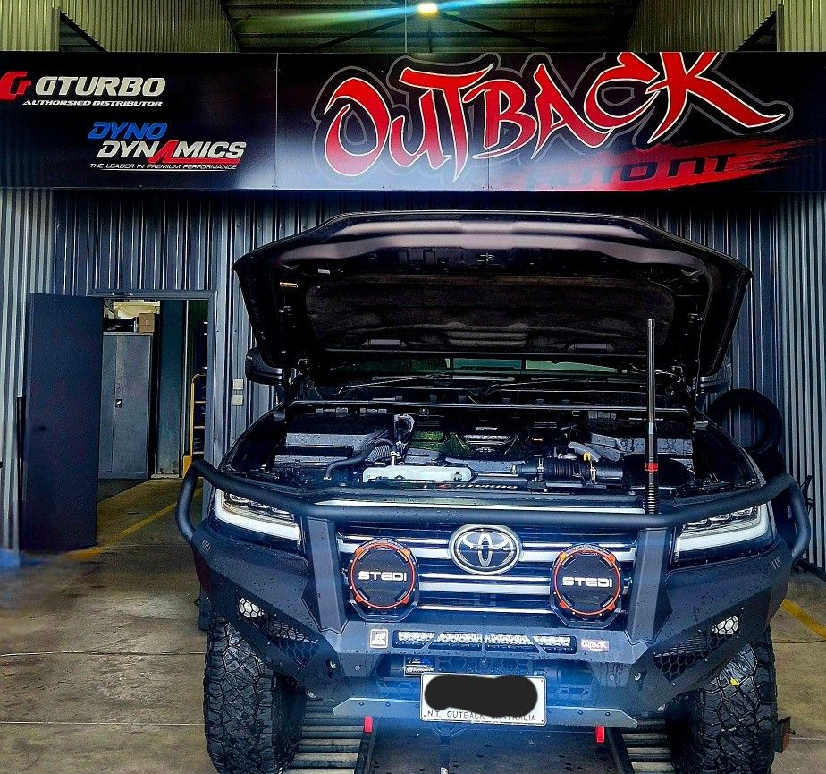 Blue Toyota SUV with hood open in a garage, front view with off-road lights and rugged tires — Outback Auto NT in Berrimah, NT