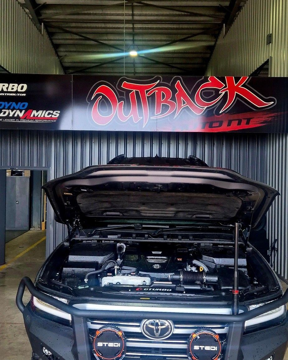 A Black Toyota With an Open Hood is Parked Inside a Workshop — Mechanic in Darwin, NT