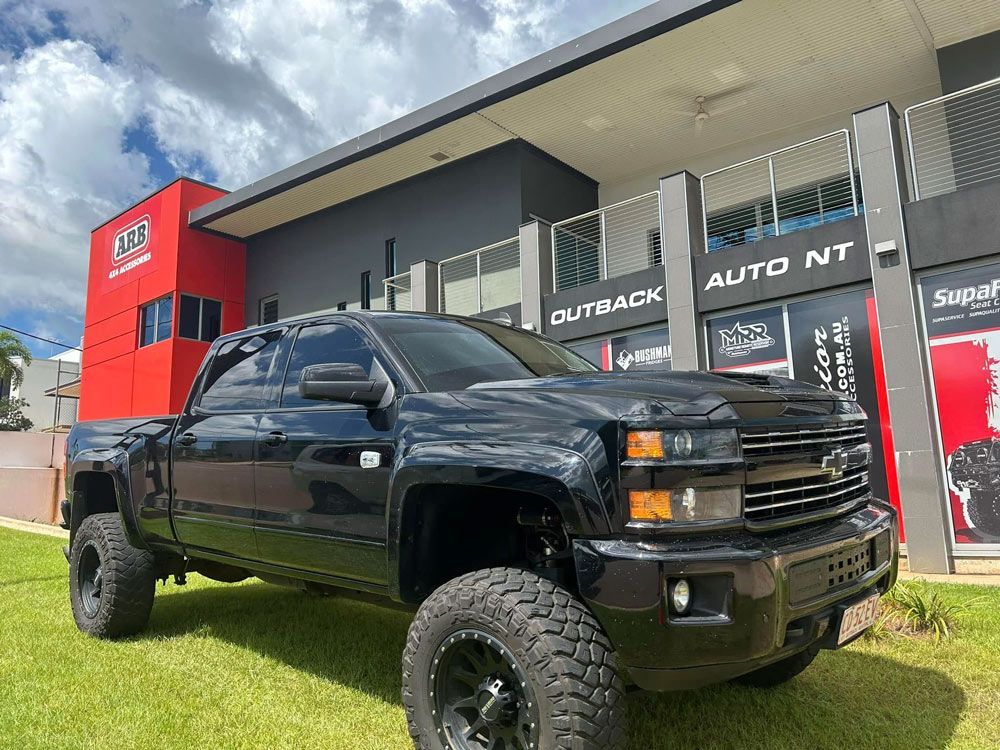 Black Vehicle Parked Outside The Outback Auto NT Building