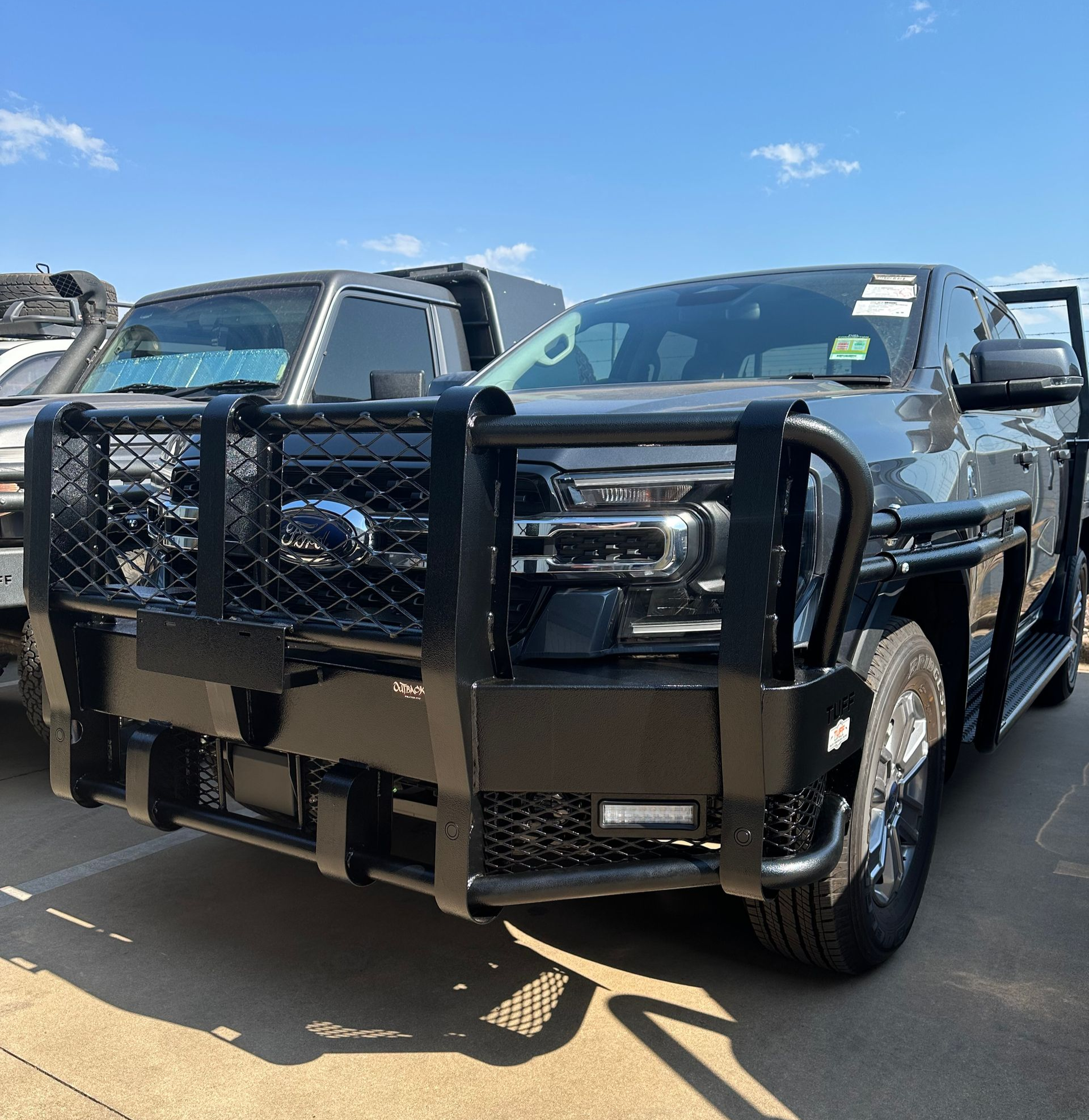 Black pickup truck with heavy-duty grille guard parked in a lot on a sunny day — Outback Auto NT in Berrimah, NT