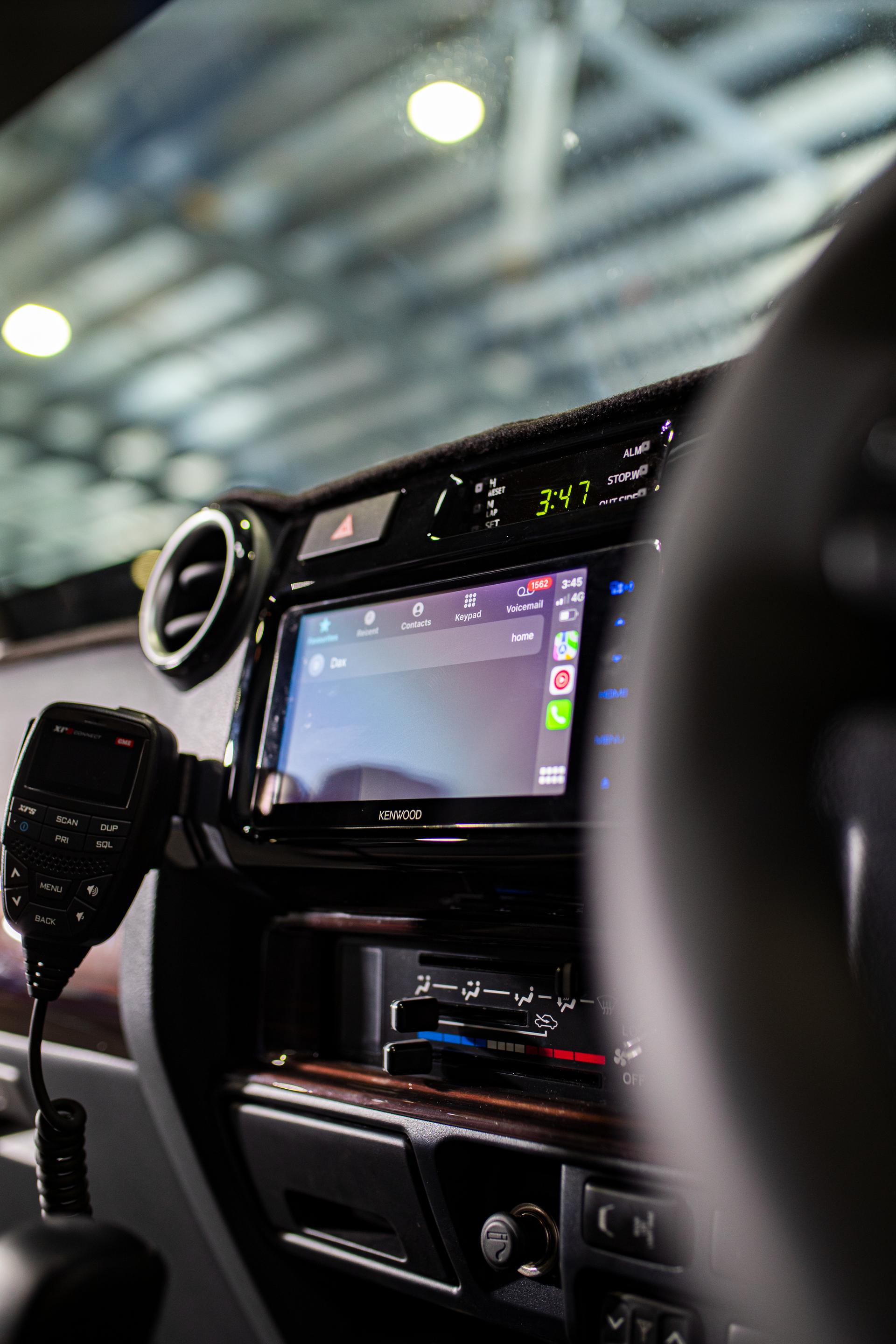 Car interior with a dashboard display and steering wheel, seen from the front passenger side. — Outback Auto NT in Berrimah, NT