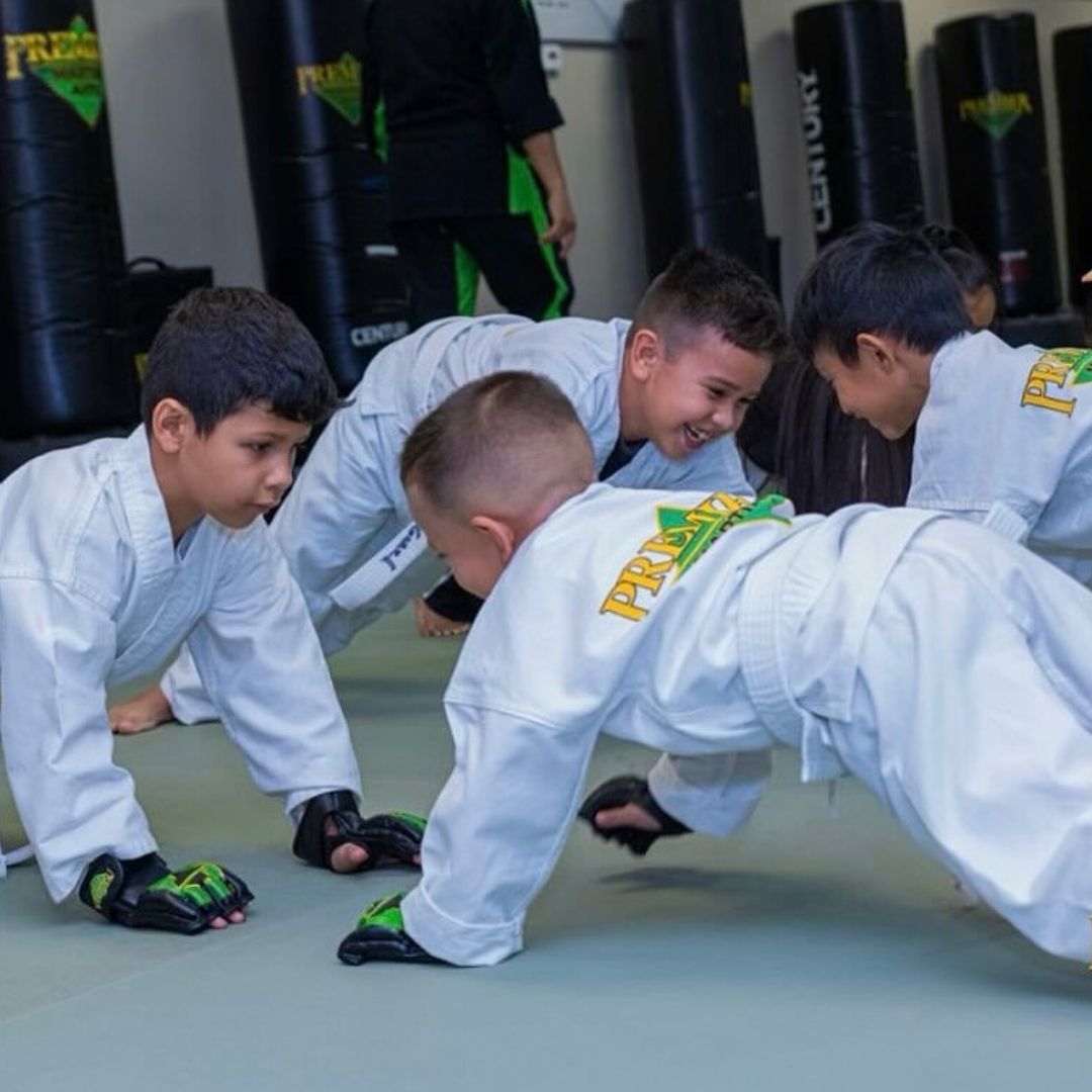 A boy and a girl are practicing taekwondo together.