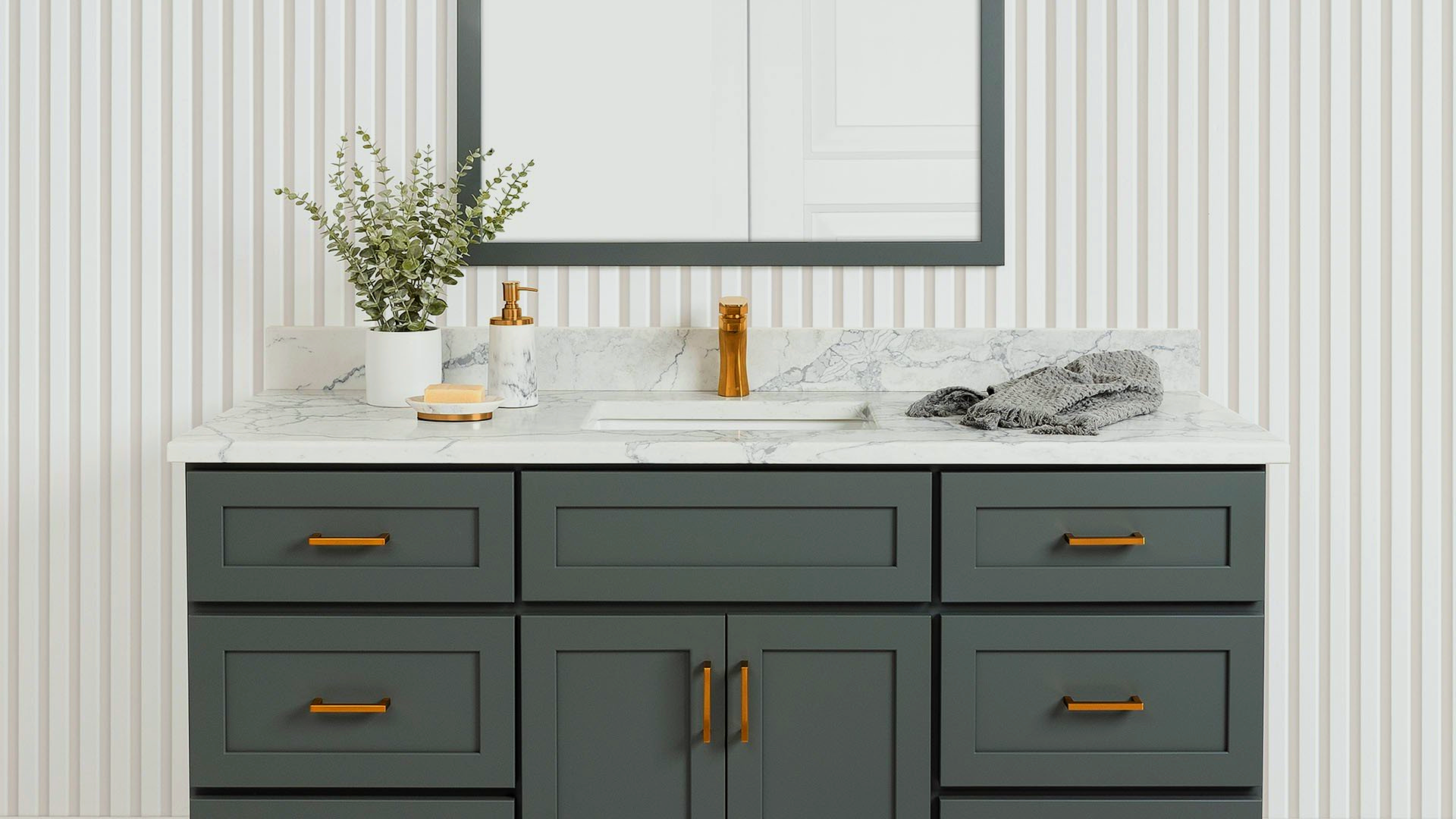 A bathroom vanity with a sink, mirror and drawers.