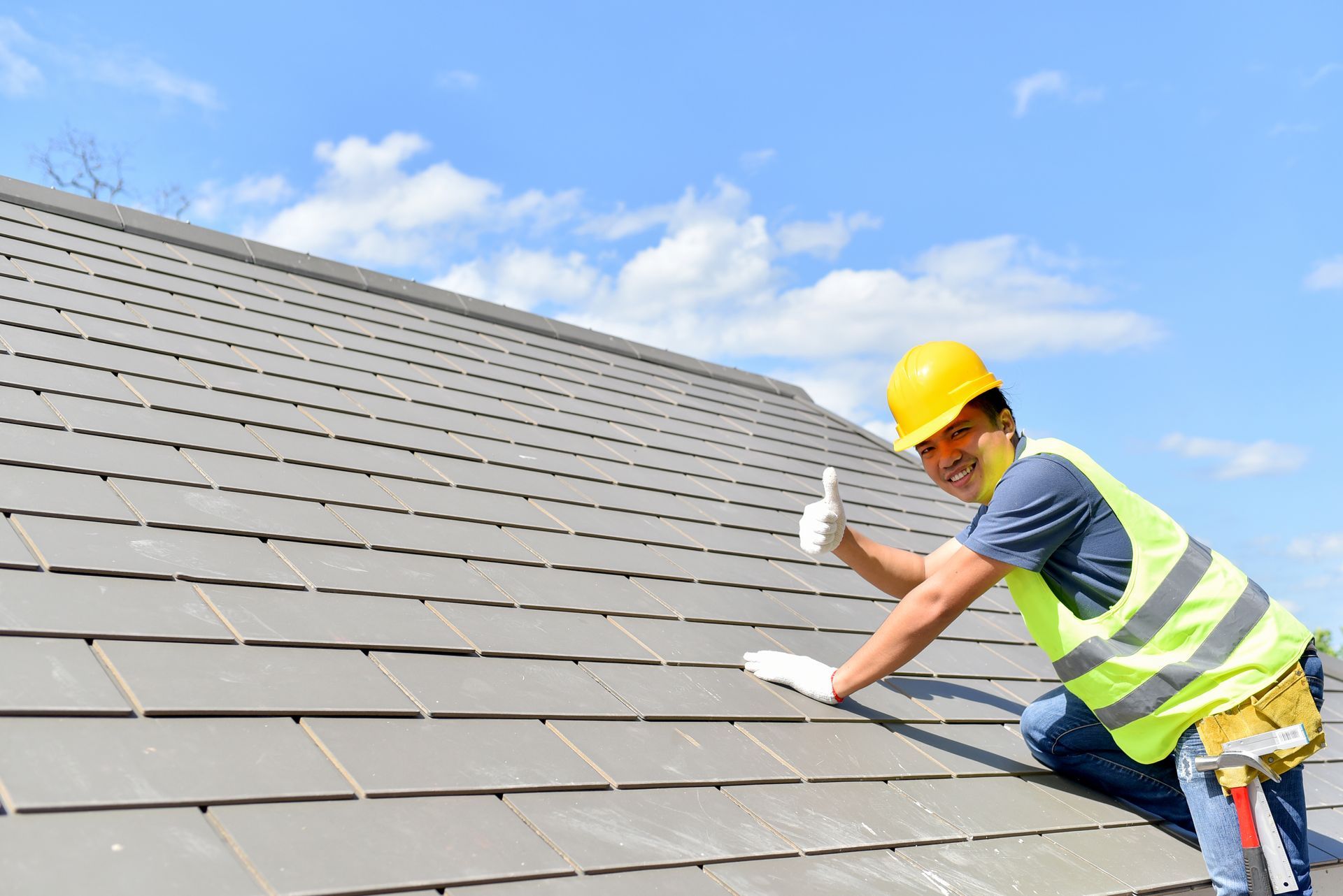 Builder working on roof of new building.